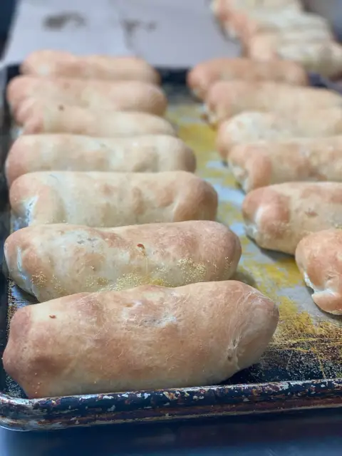 Fresh baked pepperoni rolls on a tray