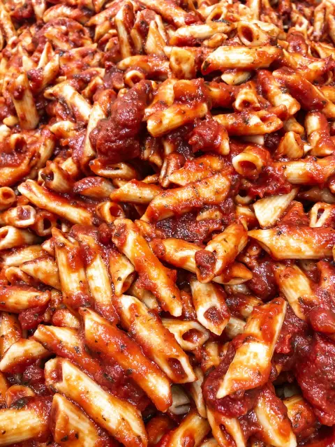 A pan of baked mostaccioli in red sauce